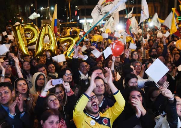 Crowds in Bogota celebrate the peace treaty that is hoped will end the 50-year war between the Colombian government and Farc rebels. Picture: AFP/Getty Images