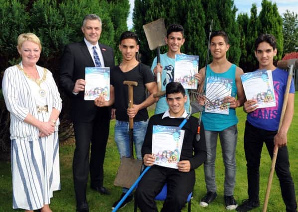 Brothers Ahmad and Ayman Ahmad, Moatasem and Ebrahim Andoura and Issa Al Ahmad with Provost Anne Hall and Councillor Mark Macmillan. Picture: Renfrewshire Council/PA Wire
.