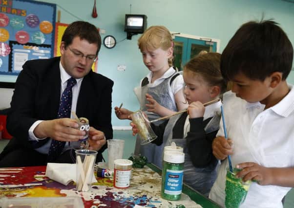 Mark McDonald with primary school children, who he believes will benefit from early exposure to education