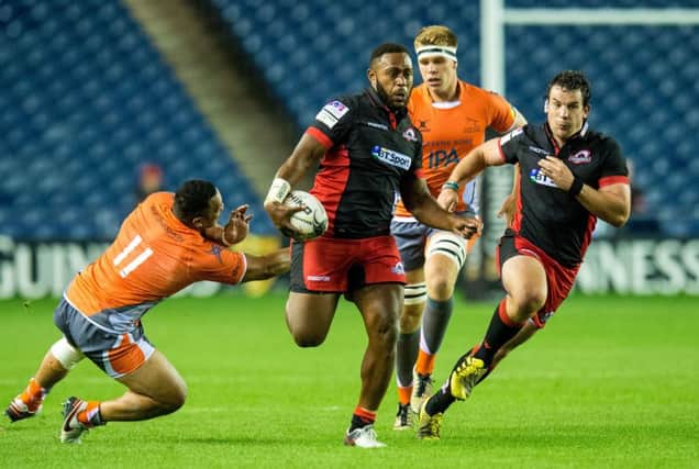 Edinburgh's Solomoni Rasolea, centre, evades a challenge on the way to setting Duncan Weir up for his try. Picture: SNS