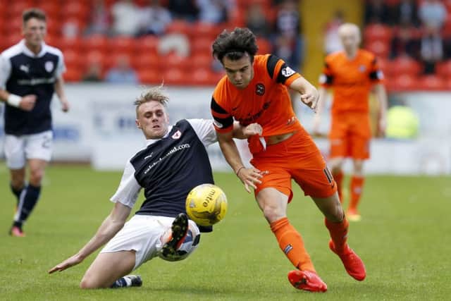 Dundee Uniteds Scott Fraser, right, shrugs off Raith Rovers defender Kevin McHattie.
