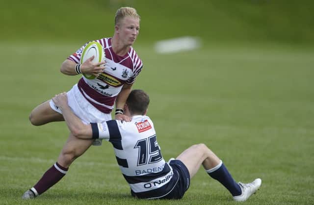 Watsonians scrum-half Weiss Cullen tries to evade the clutches of Heriots No15 Gavin Parker. Picture: Neil Hanna