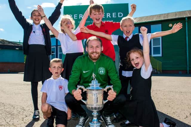 Hibernian player Martin Boyle takes the Scottish Cup on a visit to Hermitage Park Primary School. Picture: Ross Parker/SNS