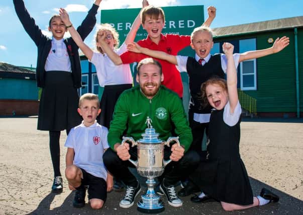Hibernian player Martin Boyle takes the Scottish Cup on a visit to Hermitage Park Primary School. Picture: Ross Parker/SNS