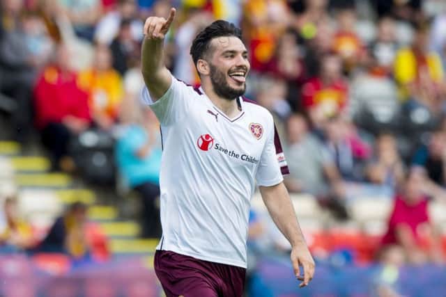 Tony Watt celebrates having scored the winning goal for Hearts in their match at Partick Thistle. Picture: SNS