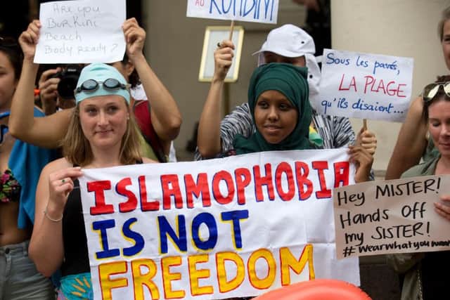 Protesters holds a sign which reads " Islamophobia is not freedom" Picture: AFP
