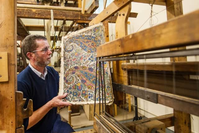 Dan Coughlan curator of textiles at Paisley Museum, holds a pattern beside a loom at the the launch of the Paisley Make Festival of Creativity and Design. Picture: John Devlin.