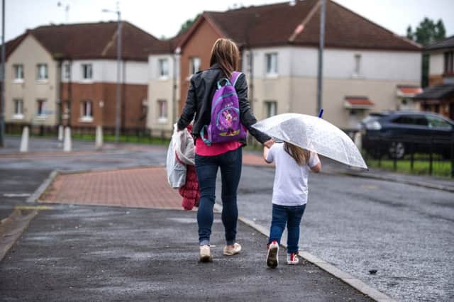 A mother and daughter walk home in Ferguslie Park. Picture: John Devlin