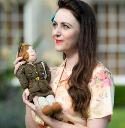 Newbattle Abbey College will host a wartime revival to mark its history as a training camp for soldiers in the 1940s. Veterans also attended to re-skill at the end of WWII.  Pictured is a model posing with a doll made at Newbattle by a member of the Auxiliary Territorial Service . PIC Andrew O'Brien.