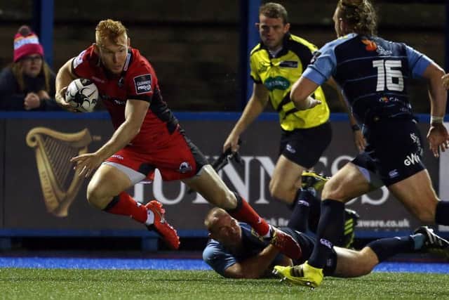 Dan Fish of Cardiff Blues slides in to tackle Edinburghs Rory Scholes in Saturdays first round of Guinness Pro12 games. The visitors must follow this defeat with a tough run of fixtures against Leinster, Munster and Connacht. Picture: Fotosport