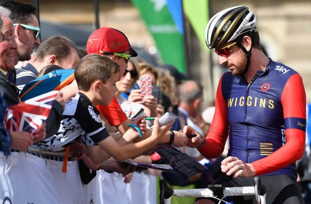 GLASGOW, SCOTLAND - SEPTEMBER 04: Cyclist  Sir Bradley Wiggins signs autographs prior to the start of stage 1 of the Tour of Britain from Glasgow to Castle Douglas on September 4, 2016 in Glasgow, Scotland. Riders including Olympic medallists Mark Cavendish and Sir Bradley Wiggins, will depart out of Glasgow's George Square doing a circuit of the city before heading south passing through Kilmarnock and finishing in Castle Douglas.  (Photo by Jeff J Mitchell/Getty Images)