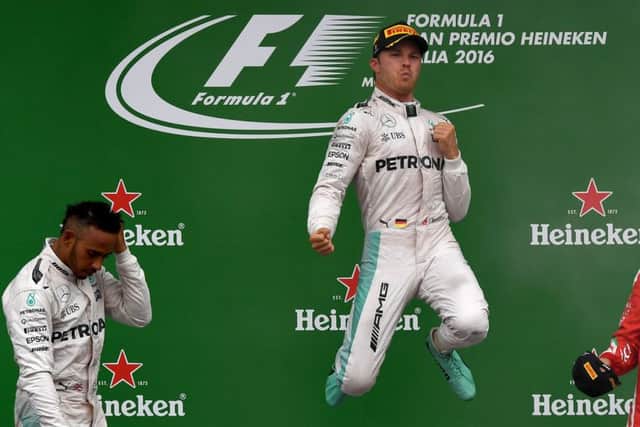 Nico Rosberg, centre, celebrates on the podium next to second placed Lewis Hamilton, left, and Sebastian Vettel. Picture: AFP/Getty Images
