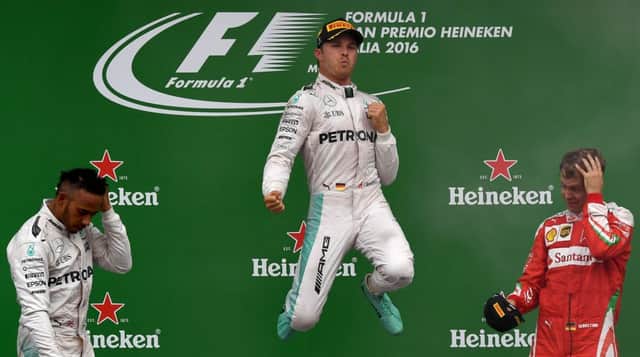 Nico Rosberg, centre, celebrates on the podium next to second placed Lewis Hamilton, left, and Sebastian Vettel. Picture: AFP/Getty Images