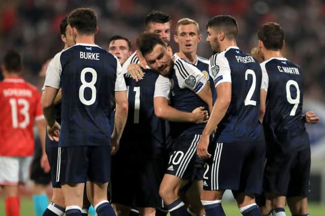 Robert Snodgrass is congratulated after scoring Scotland's third goal from the penalty spot at the Ta'Qali National Stadium. Picture: PA