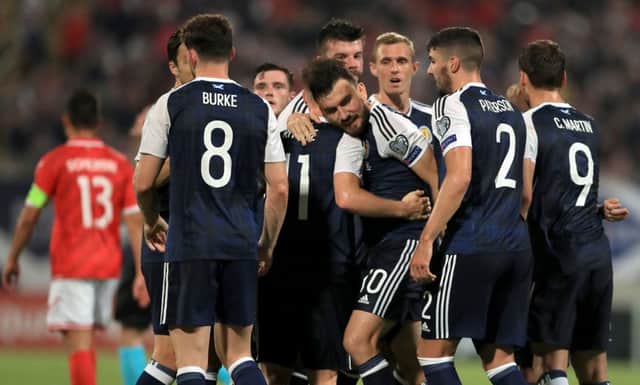 Robert Snodgrass is congratulated after scoring Scotland's third goal from the penalty spot at the Ta'Qali National Stadium. Picture: PA