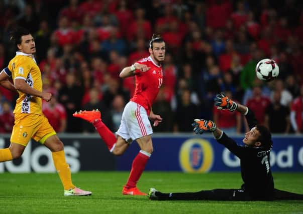 Gareth Bale scores the first of his two goals against Moldova. Picture: Getty.