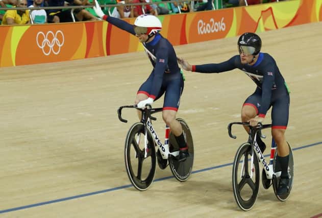 Jason Kenny, left, is congratulated by Glasgow-born teammate Callum Skinner on winning the gold medal after the men's sprint final at the Rio Olympics. Picture: Bryn Lennon/Getty Images