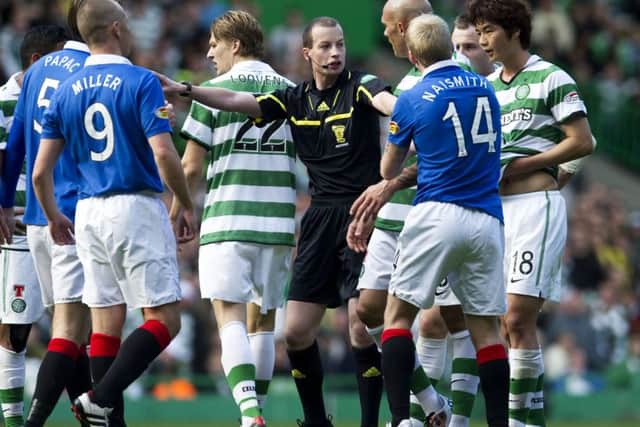 Referee Willie Collum is surrounded by players in a 2010 Celtic-Rangers game. Picture: Sammy Turner/SNS
