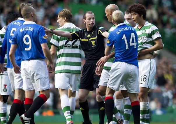 Referee Willie Collum is surrounded by players in a 2010 Celtic-Rangers game. Picture: Sammy Turner/SNS