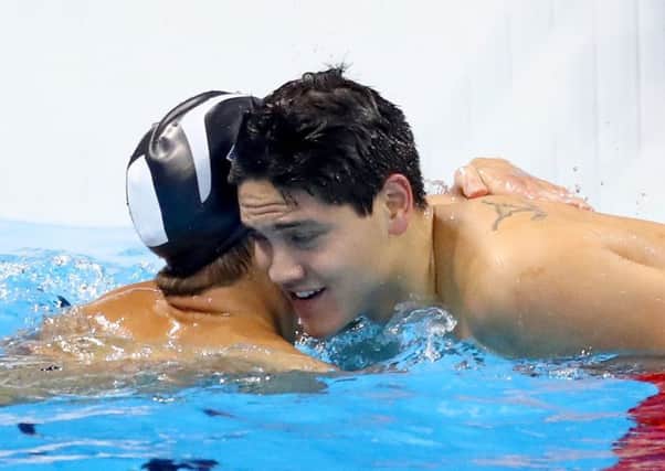 Joseph Schooling is hugged by Michael Phelps, whom he beat at last months Rio Olympics. Picture: Getty Images