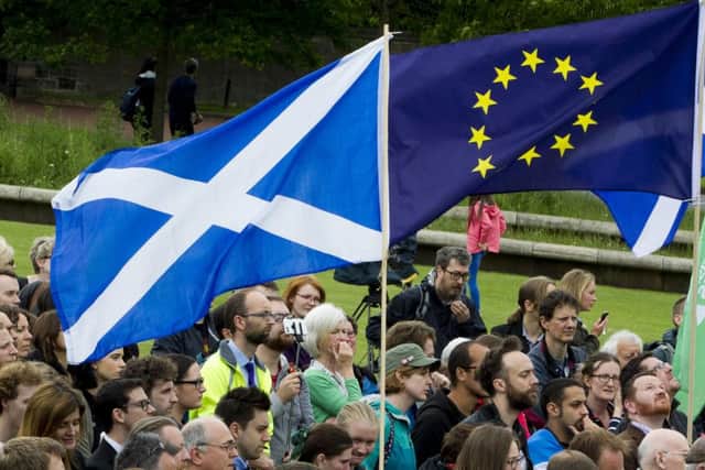 Pro-EU supporters gather outside the Scottish Parliament following the Leave vote