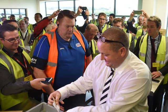 Sports Direct founder Mike Ashley empties his pockets of bank notes during a mock search at the firm's headquarters in Derbyshire. Picture: Joe Giddens/PA Wire