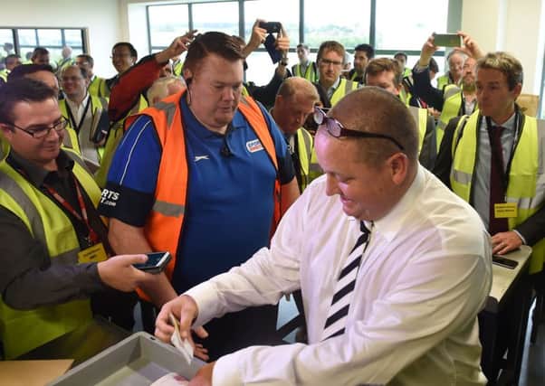 Sports Direct founder Mike Ashley empties his pockets of bank notes  during a mock search at the firm's headquarters in Derbyshire. Picture: Joe Giddens/PA Wire