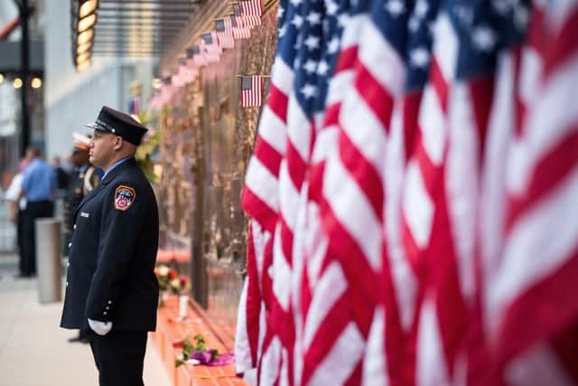 A New York City firefighter stands outside FDNY Engine 10, Ladder 10 station near the September 11 memorial site. Picture: Getty