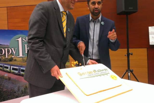 ScotRail Alliance managing director Phil Verster and transport minister Humza Yousaf cut a cake to celebrate Borders Railway's first birthday