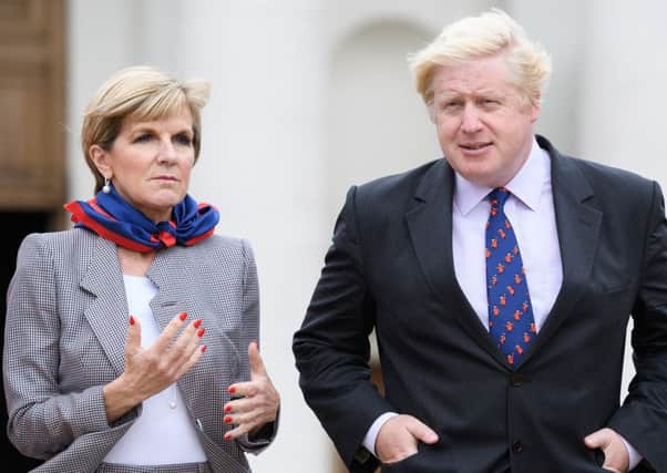 Australian Foreign Minister Julie Bishop walks with British Foreign Secretary Boris Johnson during a tour of the Royal Hospital Chelsea. Picture: Getty