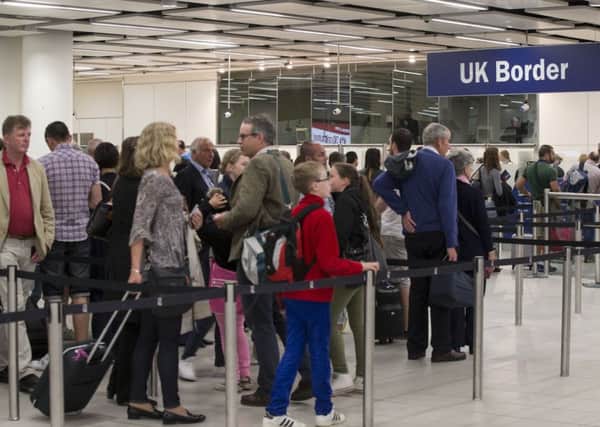 Border Force check the passports of passengers arriving at Gatwick Airport. Picture: Getty
