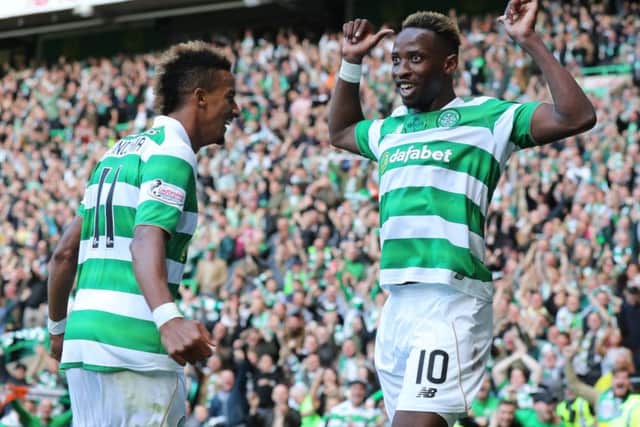 Moussa Dembele of Celtic celebrates the first goal of his hat-trick with Scott Sinclair, who also scored. Picture: Steve  Welsh/Getty Images