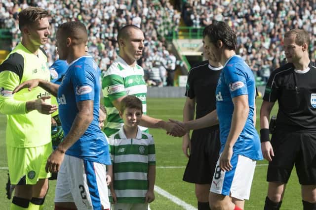 Celtic's Scott Brown shakes hands with Rangers' Joey Barton ahead of kick off. Picture: Craig Foy/SNS