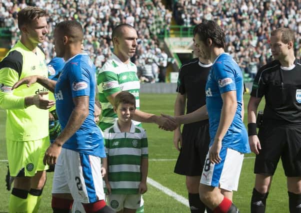 Celtic's Scott Brown shakes hands with Rangers' Joey Barton ahead of kick off. Picture: Craig Foy/SNS