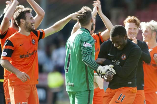 Cammy Bell is congratulated by his team-mates after saving three penalties in the 3-1 win over Dunfermline. Pic: SNS