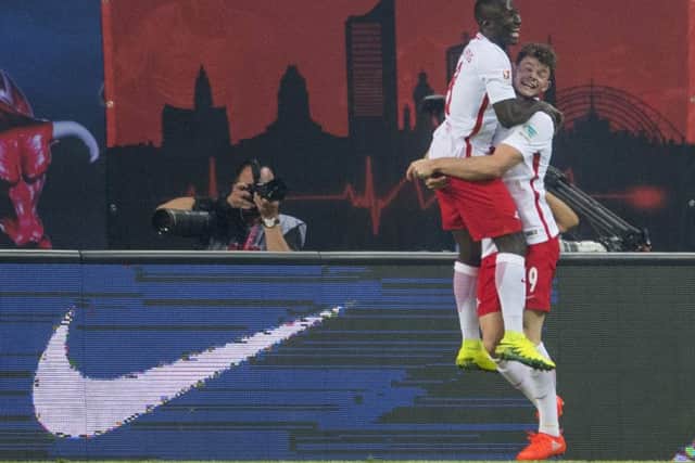Leipzig's Guinean midfielder Naby Deco Keita celebrates his winner against Dortmund with Scottish midfielder Oliver Burke. Picture: Robert Michael/AFP/Getty Images