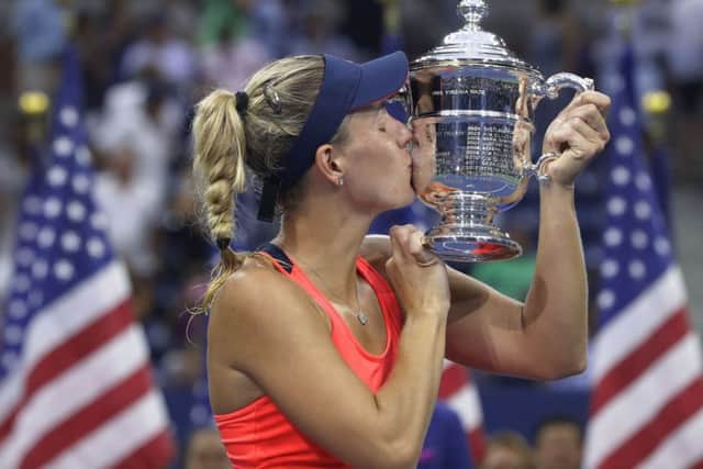 Angelique Kerber, of Germany, kisses the championship trophy after beating Karolina Pliskova, of the Czech Republic, to win the women's singles final at the US Open. Picture: Darron Cummings/AP