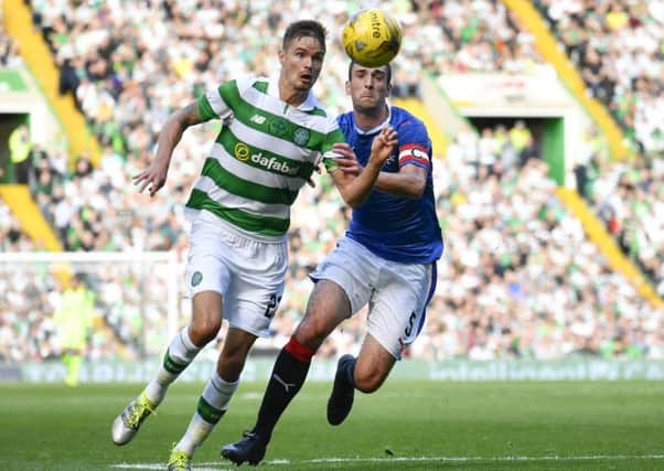 Rangers captain Lee Wallace challenges Celtic's Mikael Lustig. Picture: Rob Casey/SNS