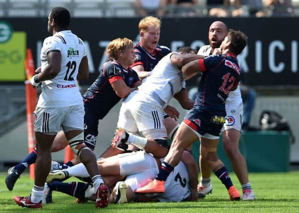 Grenoble's and Brive's players fight during the French Top 14 match at the Stade des Alpes. Picture: Jean-Pierre Clatot/AFP/Getty Images