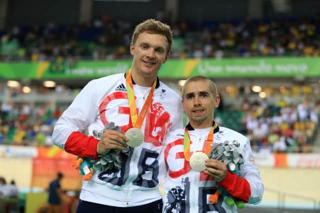 Neil Fachie, right, and guide Pete Mitchell pose with their silver medals from the mens time trial. Picture: PA