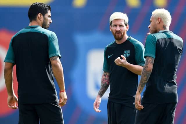 Luis Suarez, Neymar and Lionel Messi chat during training ahead of the Champions League Group C match against Celtic. Picture: David Ramos/Getty Images