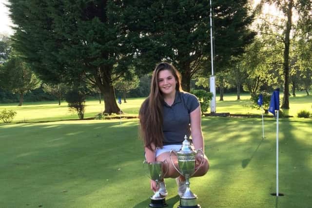 Lorna McClymont shows off her senior and junior trophies. Picture: Contributed
