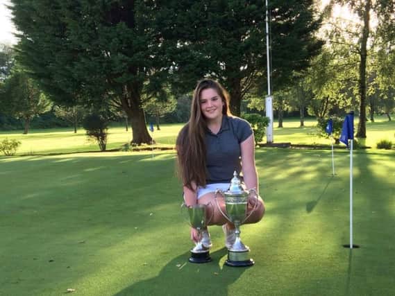 Lorna McClymont shows off her senior and junior trophies. Picture: Contributed