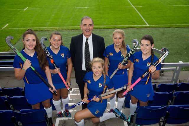 High School of Glasgow Girls 1st XI hockey team players with Colin Mair are   left to right  vice captain Stephanie Wood, captain Samantha Bell, Victoria Maguire, Mirrin Gillespie and Katie Bulloch. Picture: Contributed