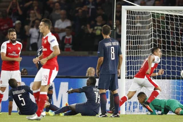 Arsenal's Alexis Sanchez, centre, scores his side's equaliser at the Parc des Princes. Picture: AP Photo/Christophe Ena