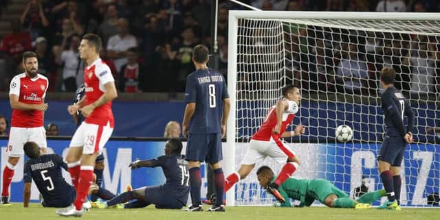 Arsenal's Alexis Sanchez, centre, scores his side's equaliser at the Parc des Princes. Picture: AP Photo/Christophe Ena