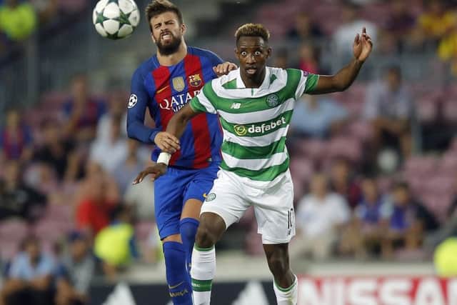 Celtic's Moussa Dembele, right, and Barcelona's Gerard Pique vie for the ball. Picture: Manu Fernandez/AP