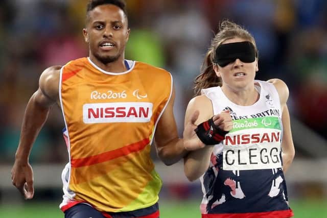 Libby Clegg and her guide, Chris Clarke, compete in the women's T11 100m. Picture: Matthew Stockman/Getty