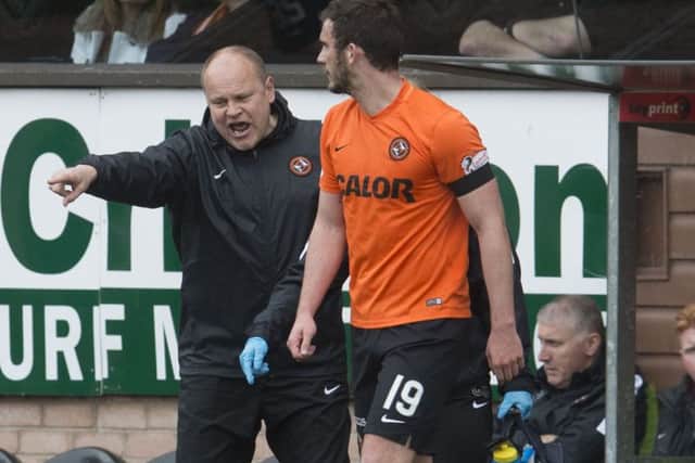 Gavin Gunning's Dundee United career ended shortly after he walked off the field with the ball in his hand, play still going on. Picture: SNS