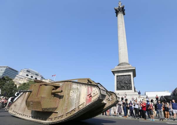 A replica World War 1 Mk IV drives past Trafalgar square to mark the 100th anniversary of the first use of the tank in battle. Picture: AP